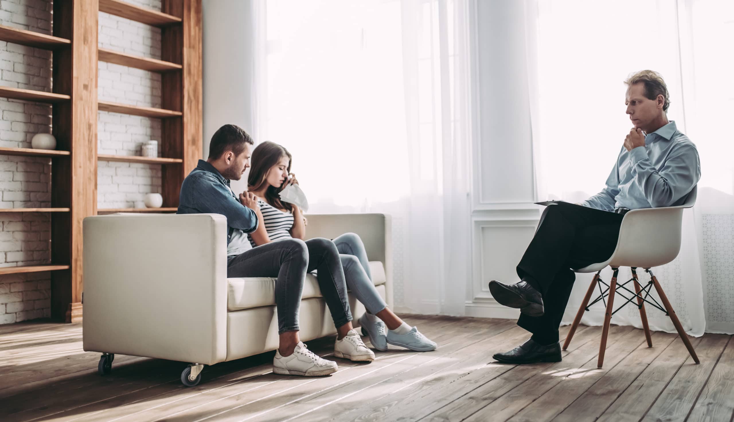 Young couple on couch in a couples therapy session